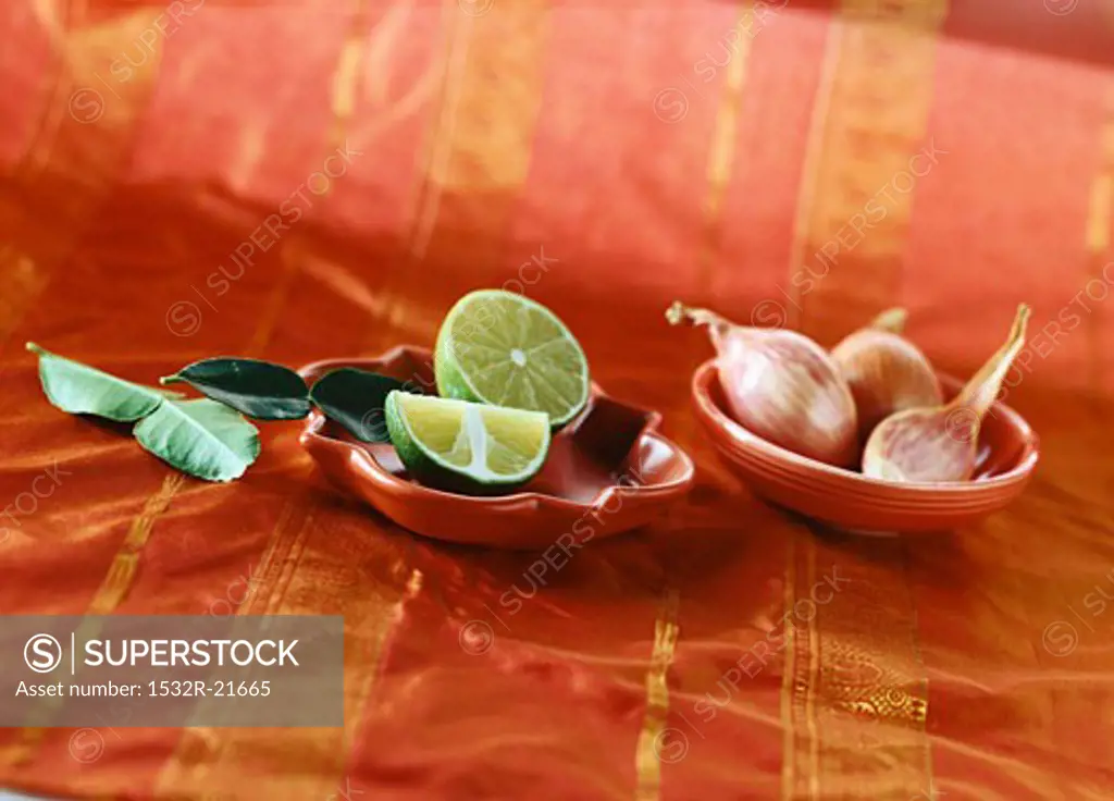 Limes and shallots in small dishes