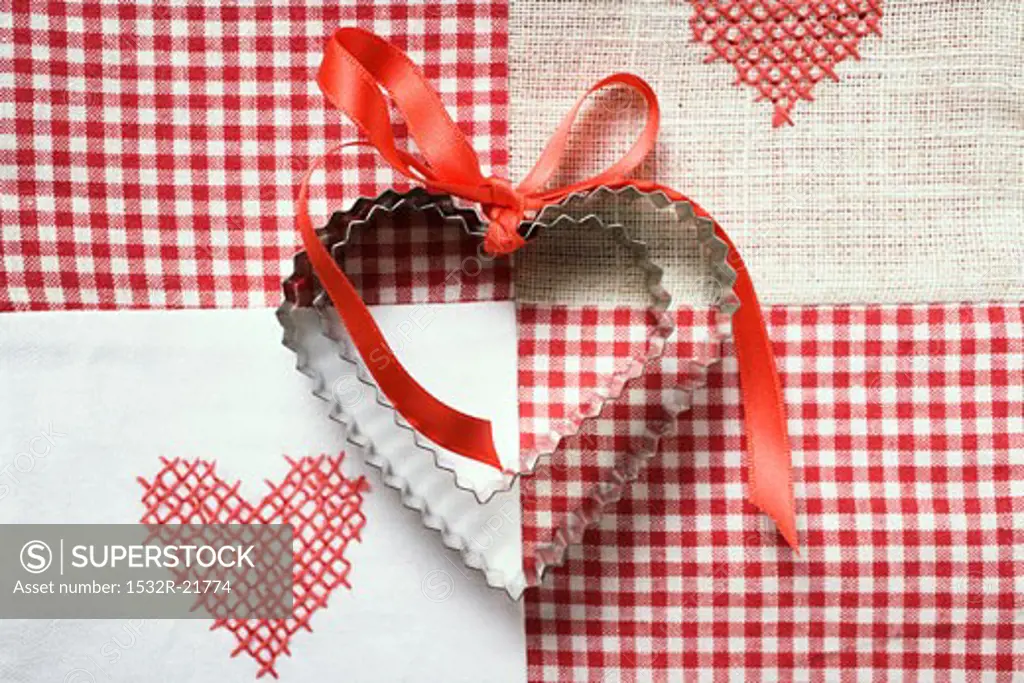 Heart-shaped biscuits with red gift ribbon