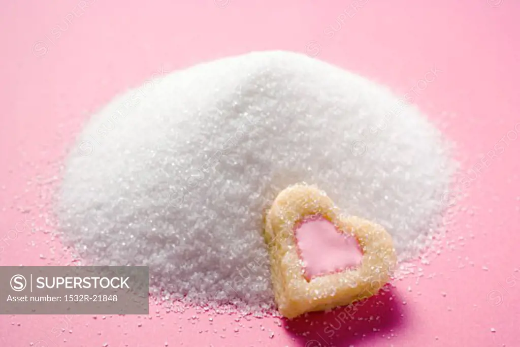 Heart-shaped biscuit on granulated sugar