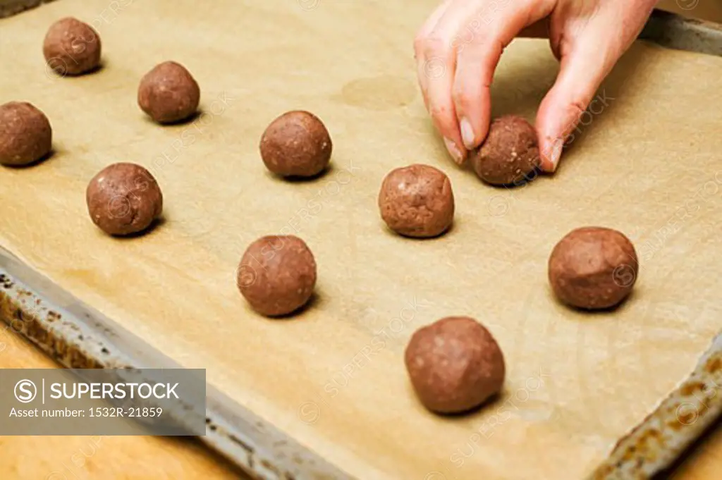 Small balls of hazelnut dough on a baking tray