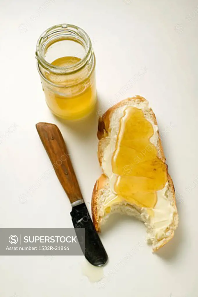 Slice of bread plait with butter and honey, a bite taken