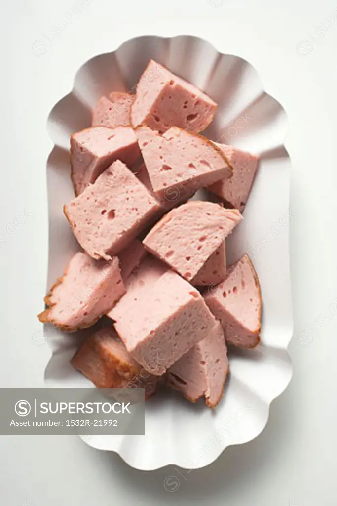 Diced Leberkäse (a type of meatloaf) in paper dish