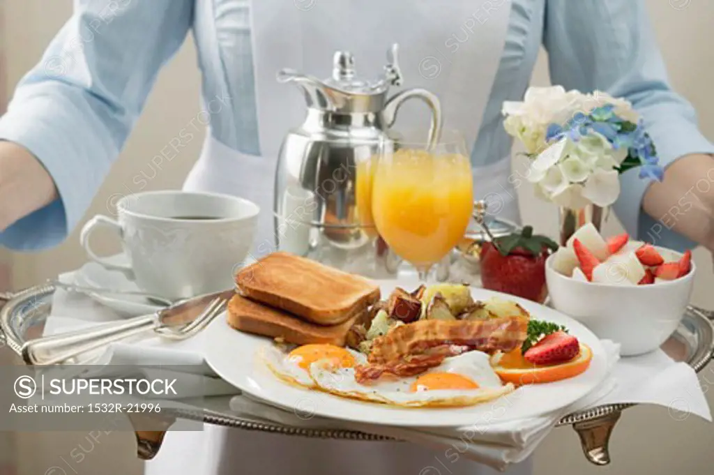 Chambermaid carrying breakfast tray