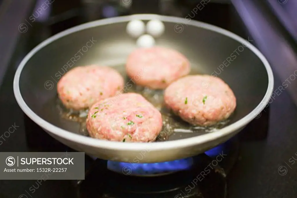 Frying burgers in a frying pan