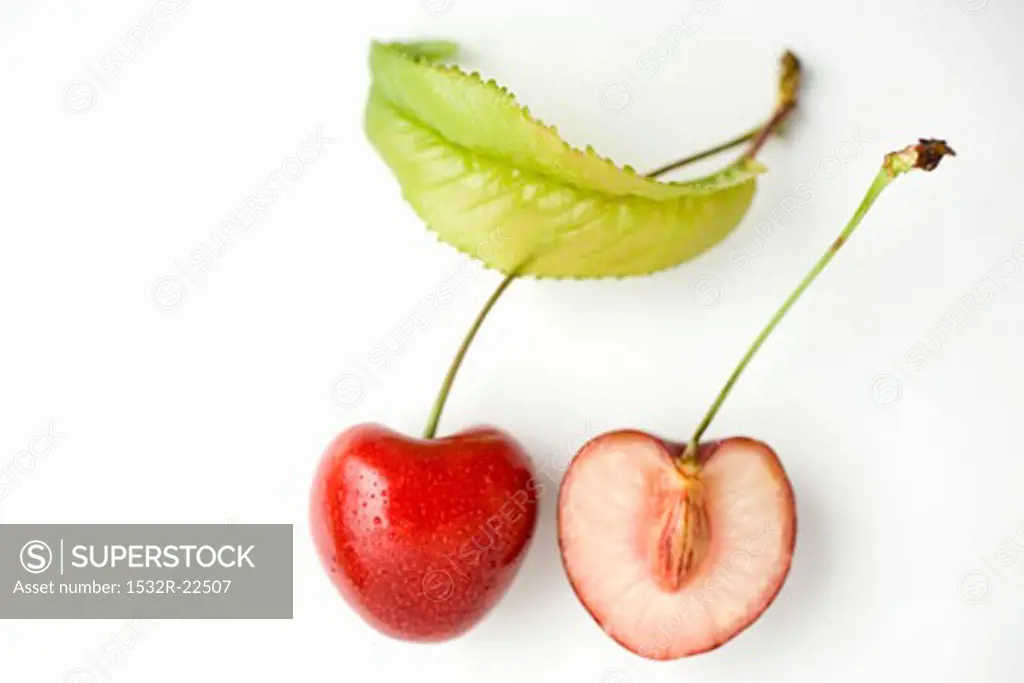 A halved cherry with leaf