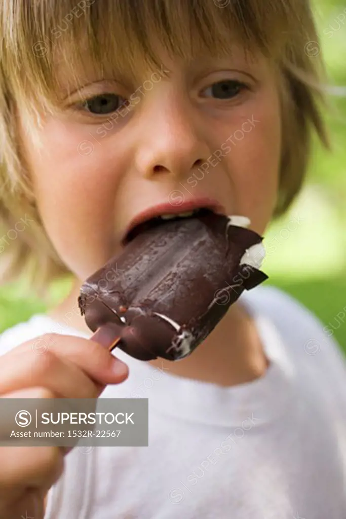 Small child eating an ice cream on a stick