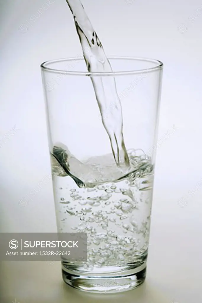 Pouring a glass of mineral water