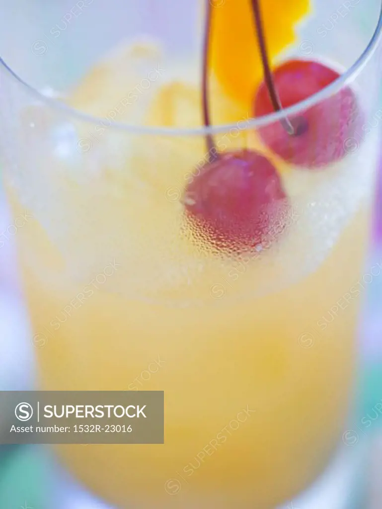 Fruit cocktail with cherries and lemon peel
