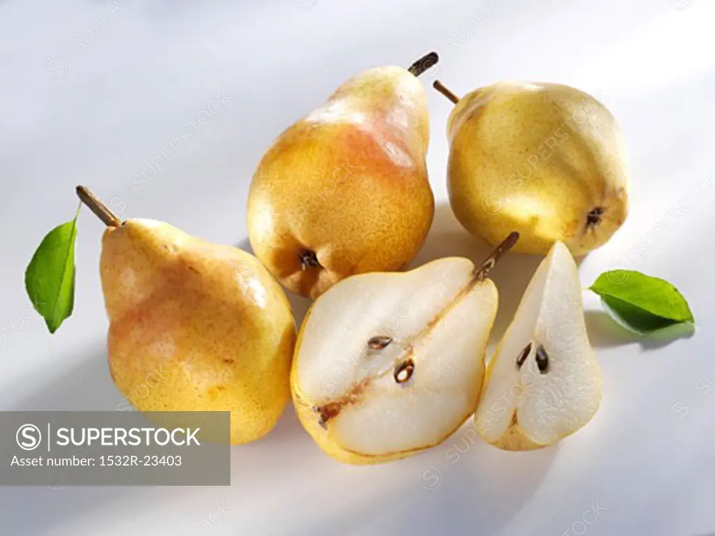 Three whole Williams pears and one cut into pieces