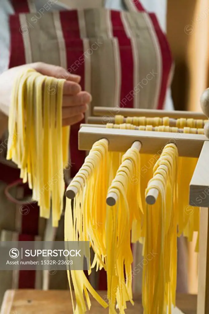 Hanging up ribbon pasta to dry