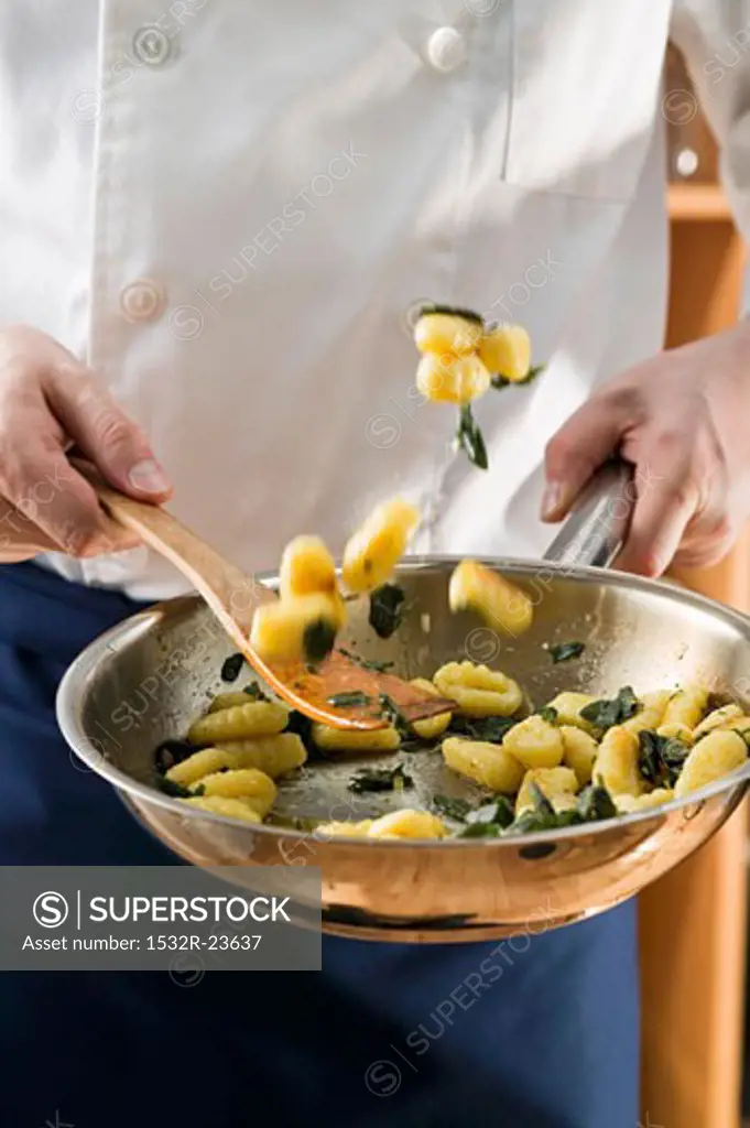 Tossing sage gnocchi in a frying pan