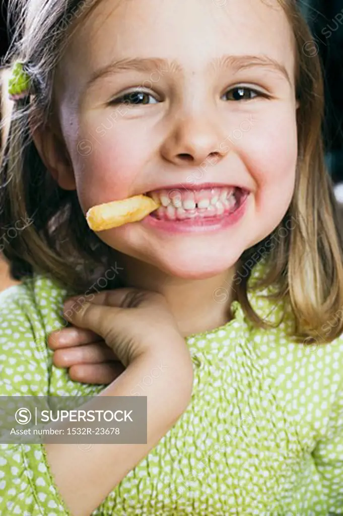 Small girl eating a chip