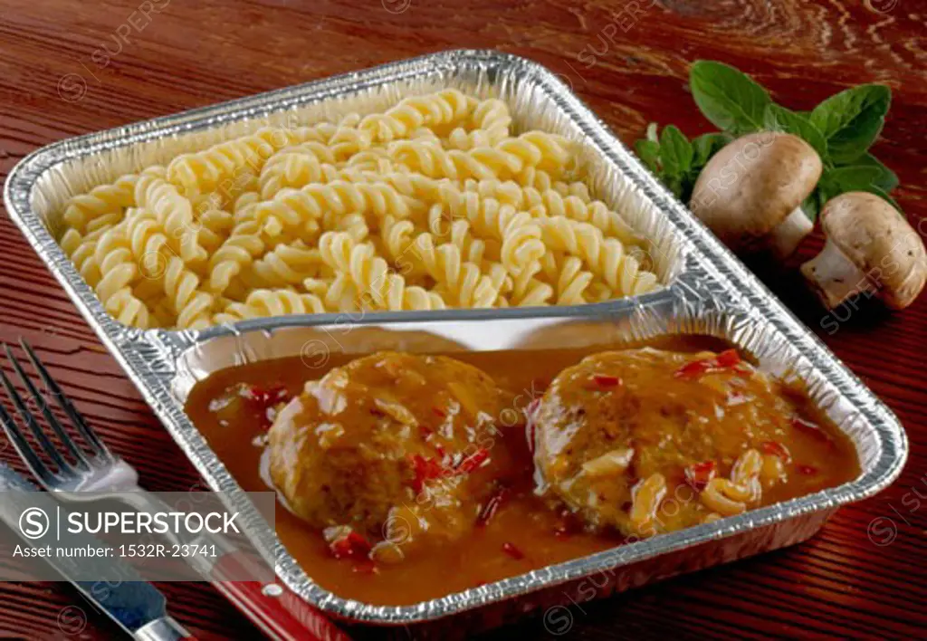 Burgers with gypsy sauce and pasta in aluminium dish