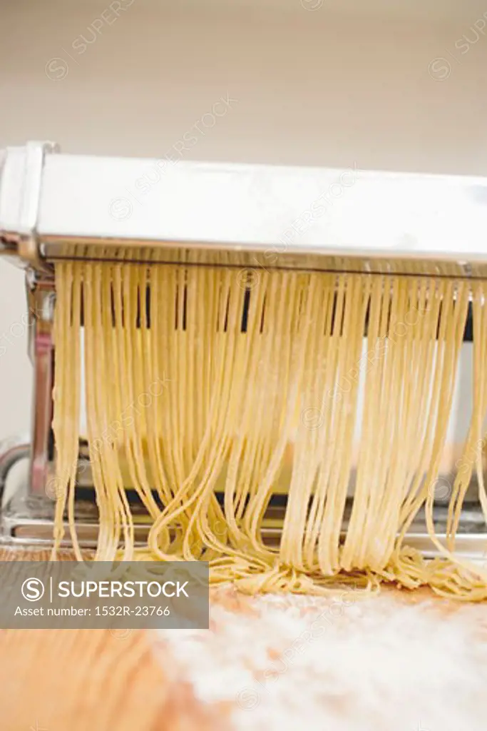 Home-made tagliatelle in pasta maker