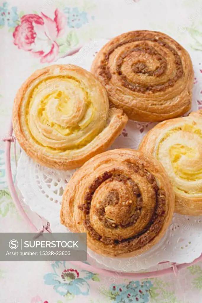 Danish pastry snails with nut and custard fillings