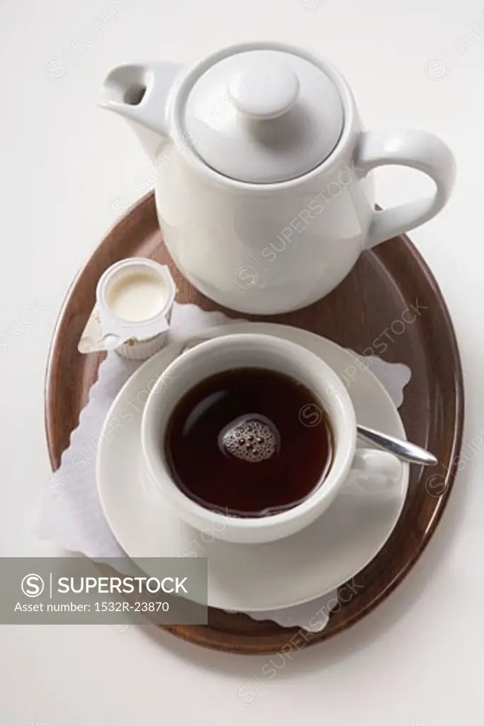 A serving of coffee with milk and sugar