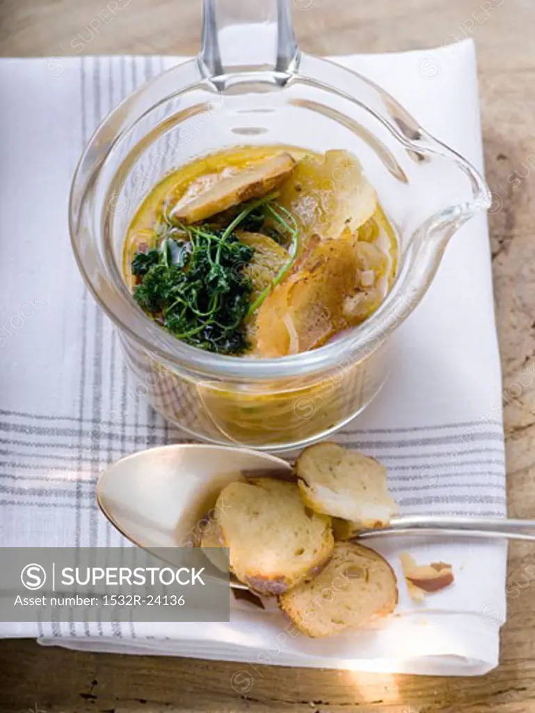 Pretzel soup with onions and deep-fried parsley