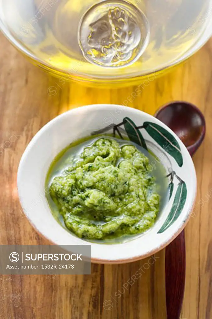 Pesto in small bowl and olive oil