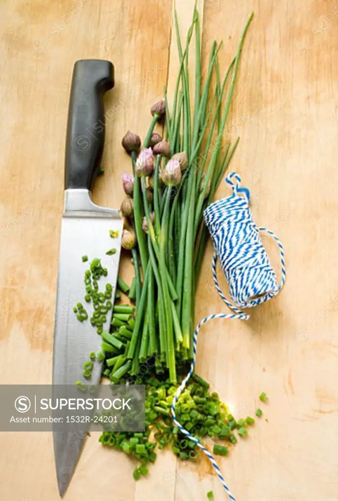 Fresh chives, partly chopped, with knife