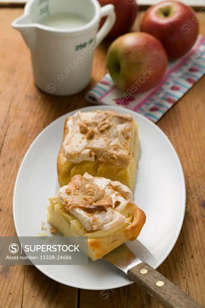 Two pieces of apple meringue cake, fresh apples & milk