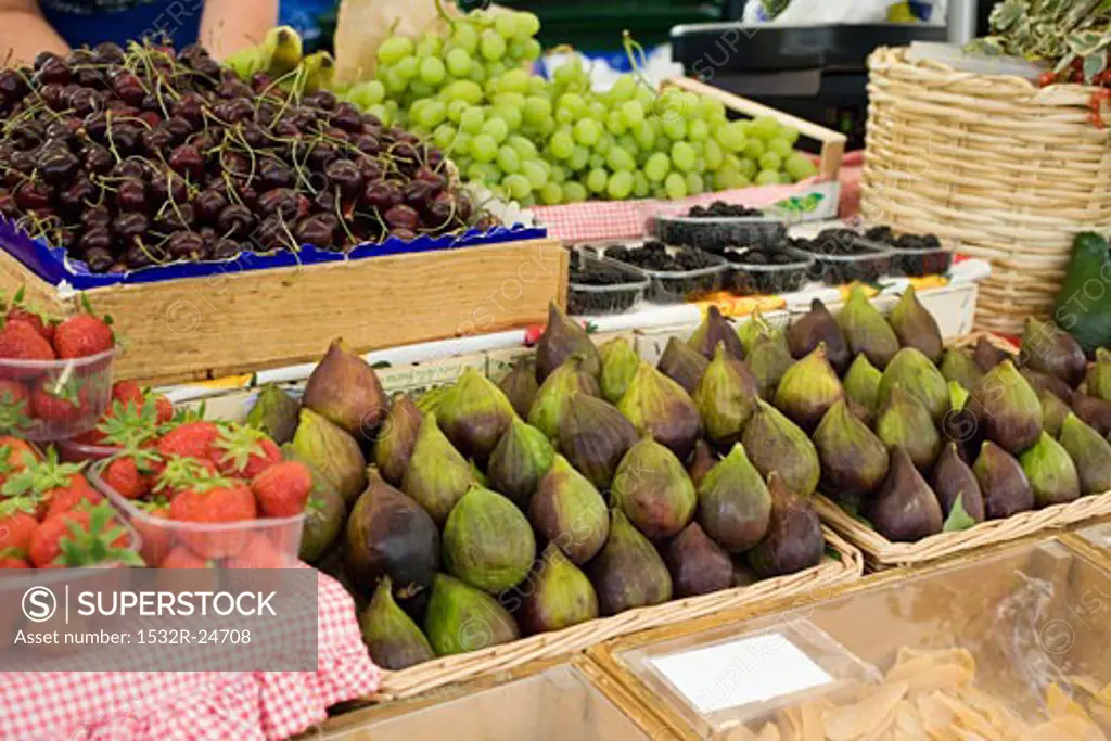 Fresh figs, cherries, grapes and berries at a market