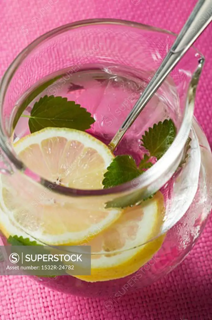 Lemonade with ice cubes and lemon balm
