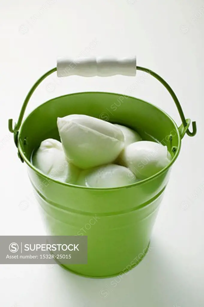 Mozzarella with brine in green bucket