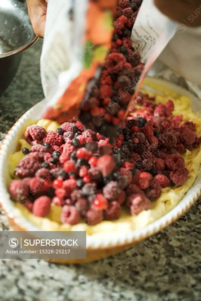 Putting berries on top on sponge