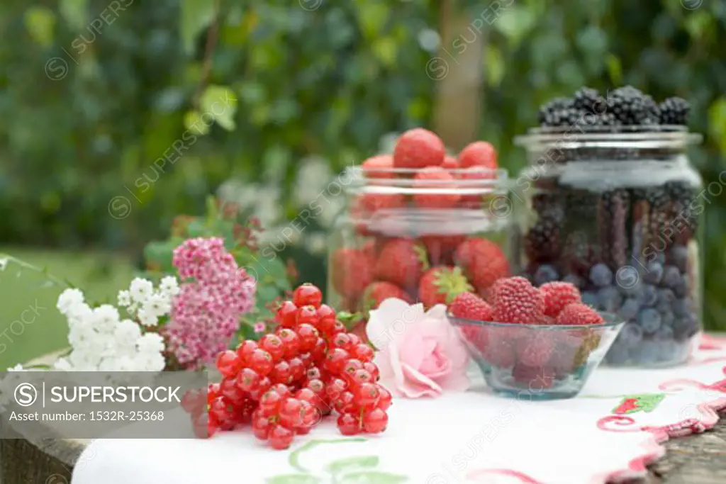 Fresh berries on rustic table out of doors