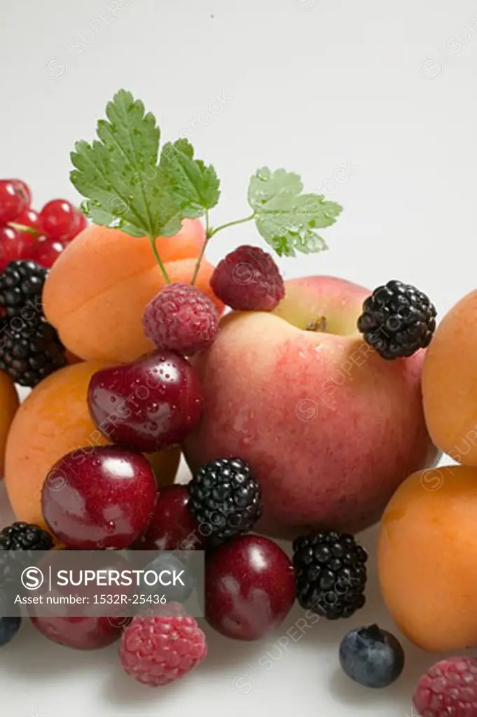 Fruit still life with stone-fruit, berries & leaves (detail)