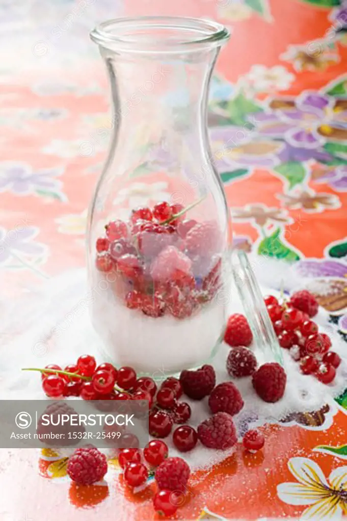 Fresh berries with sugar in carafe