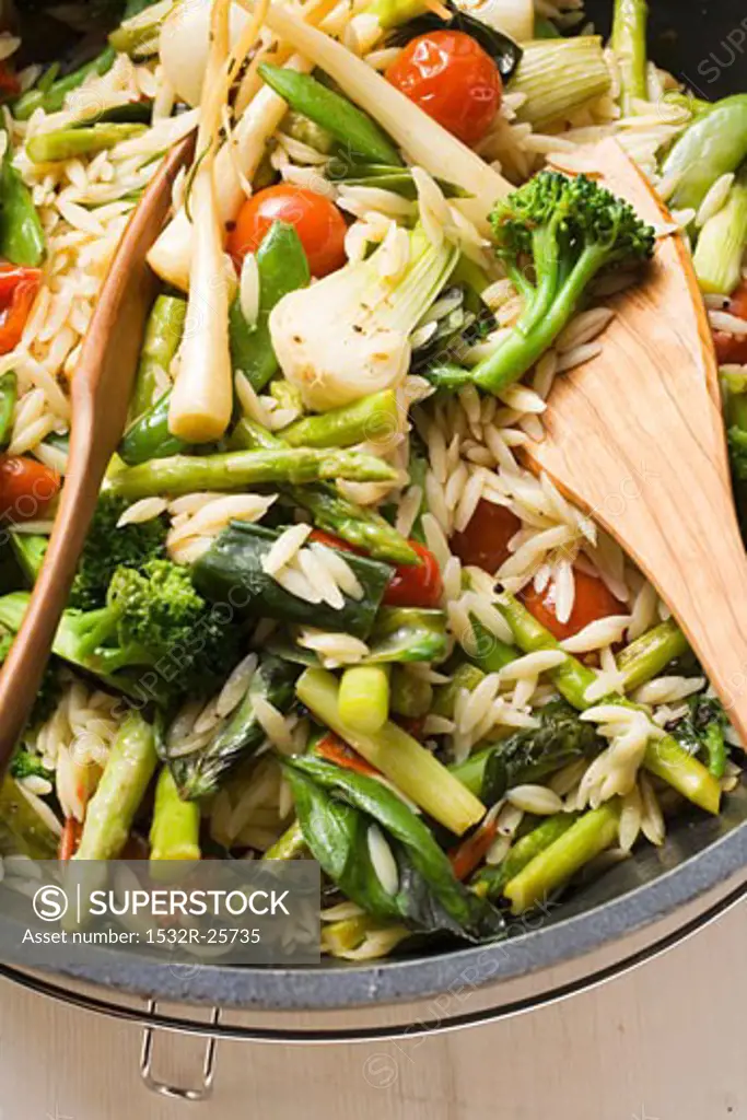 Orzo (rice-shaped pasta) with vegetables (overhead view)