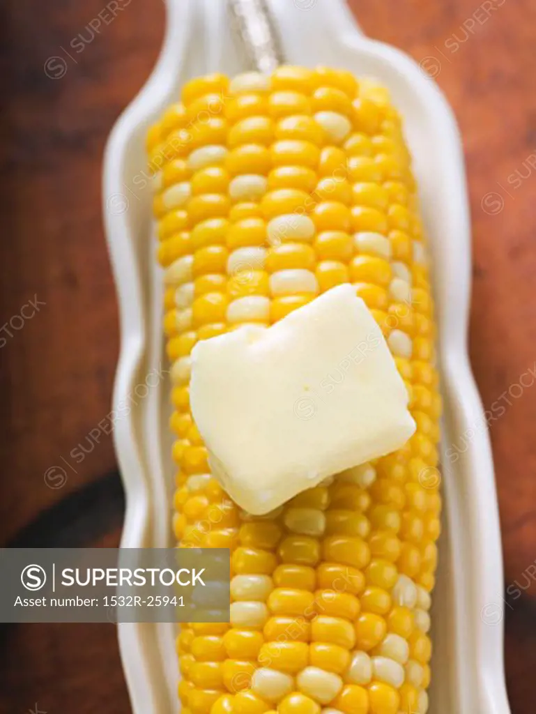 Corn on the cob with knob of melting butter (overhead view)