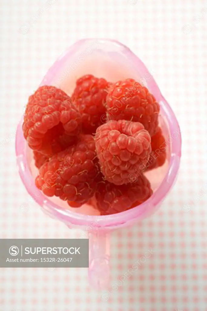 Fresh raspberries in pink jug