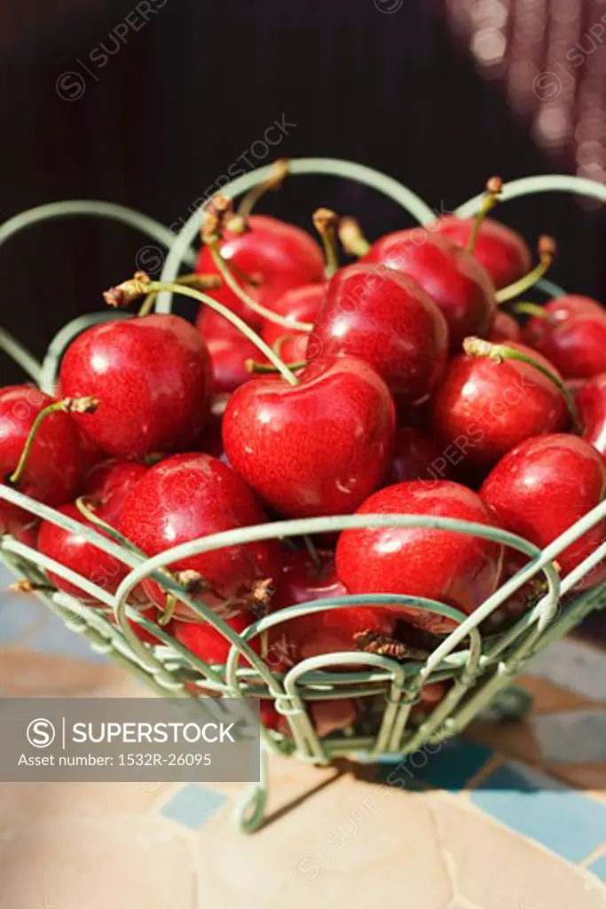 Fresh cherries in wire basket