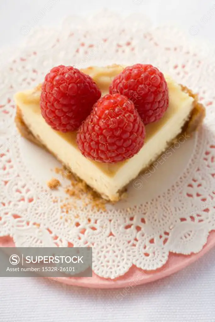 Piece of cheesecake with raspberries