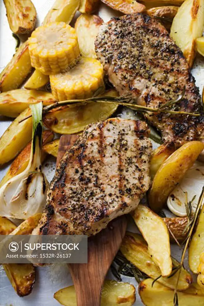 Grilled pork chops with fried potatoes and sweetcorn
