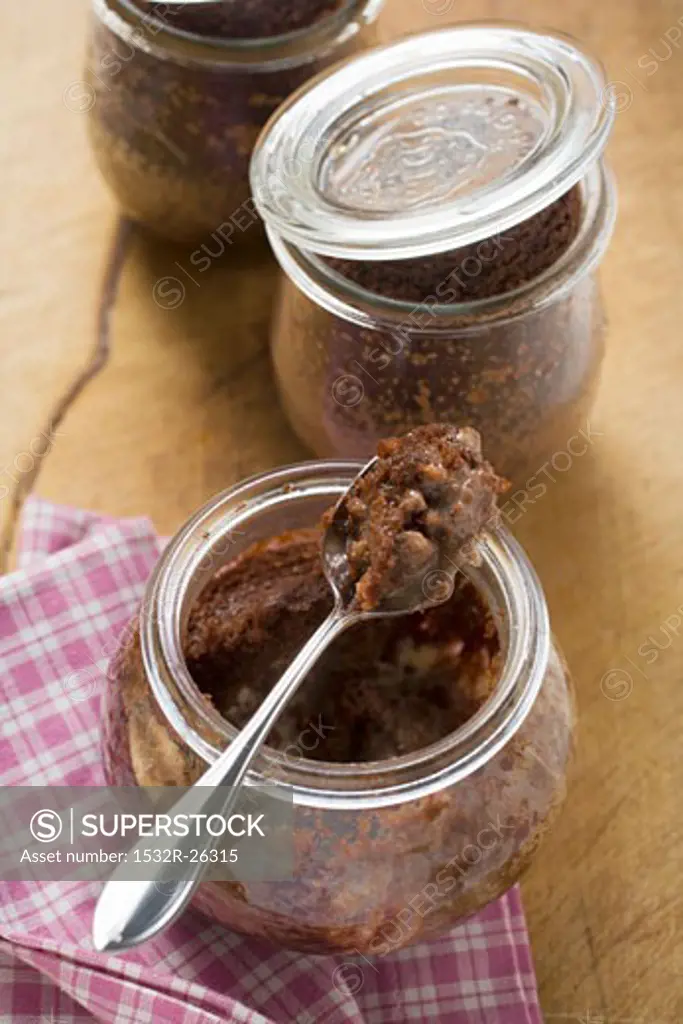 Three chocolate puddings baked in jars