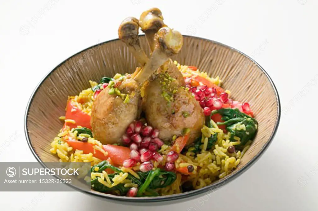 Chicken legs with saffron rice and pomegranate seeds