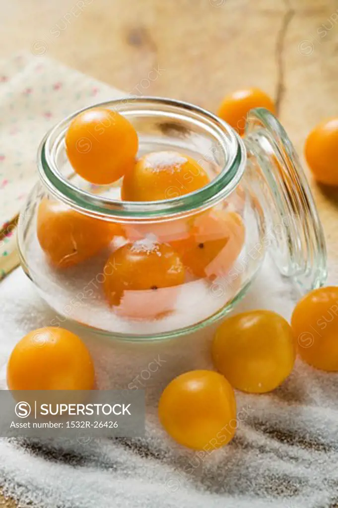 Mirabelles with sugar and preserving jar
