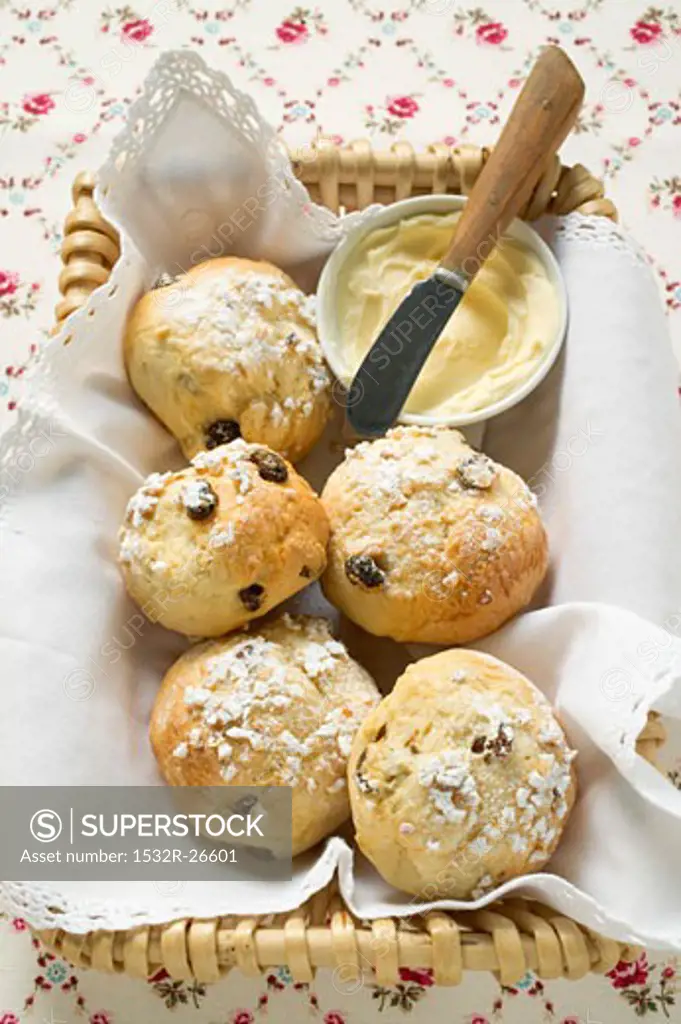 Sugared fruit scones & small dish of butter in bread basket