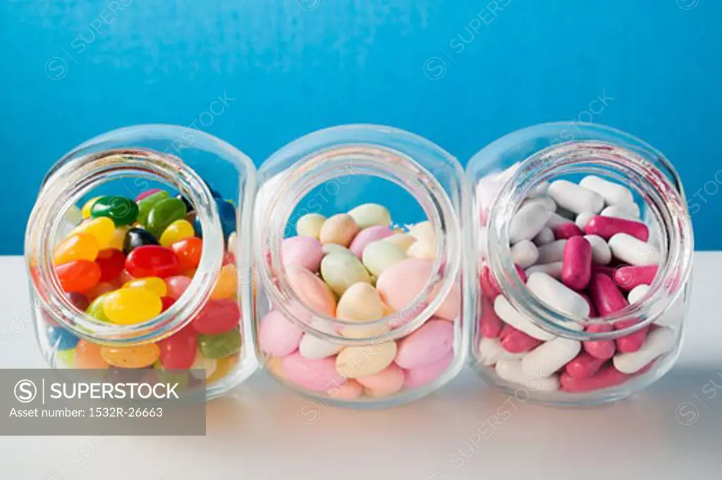 Different kinds of sweets in three sweet jars
