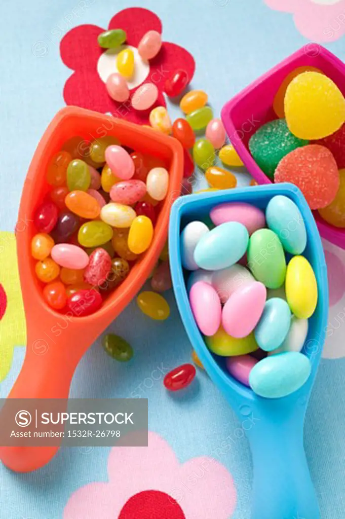 Assorted coloured sweets in plastic scoops