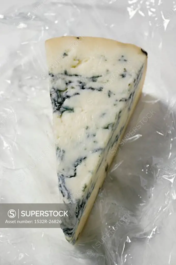 Piece of blue cheese on clingfilm