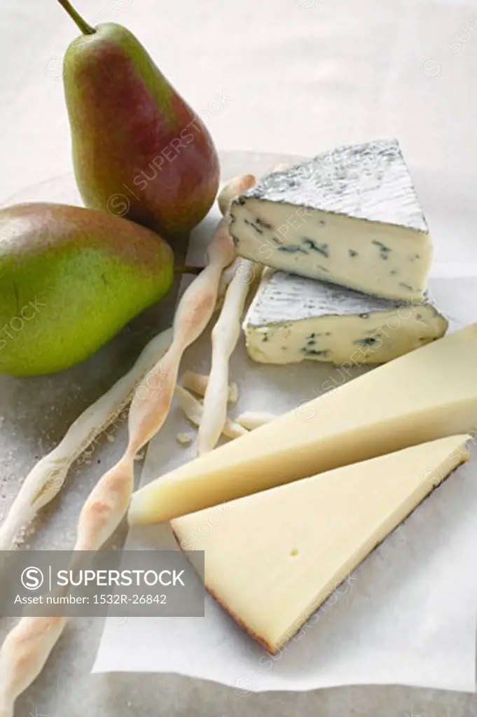Various types of cheese, fresh pears and grissini