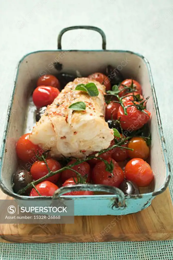 Monkfish with cherry tomatoes and olives in roasting tin