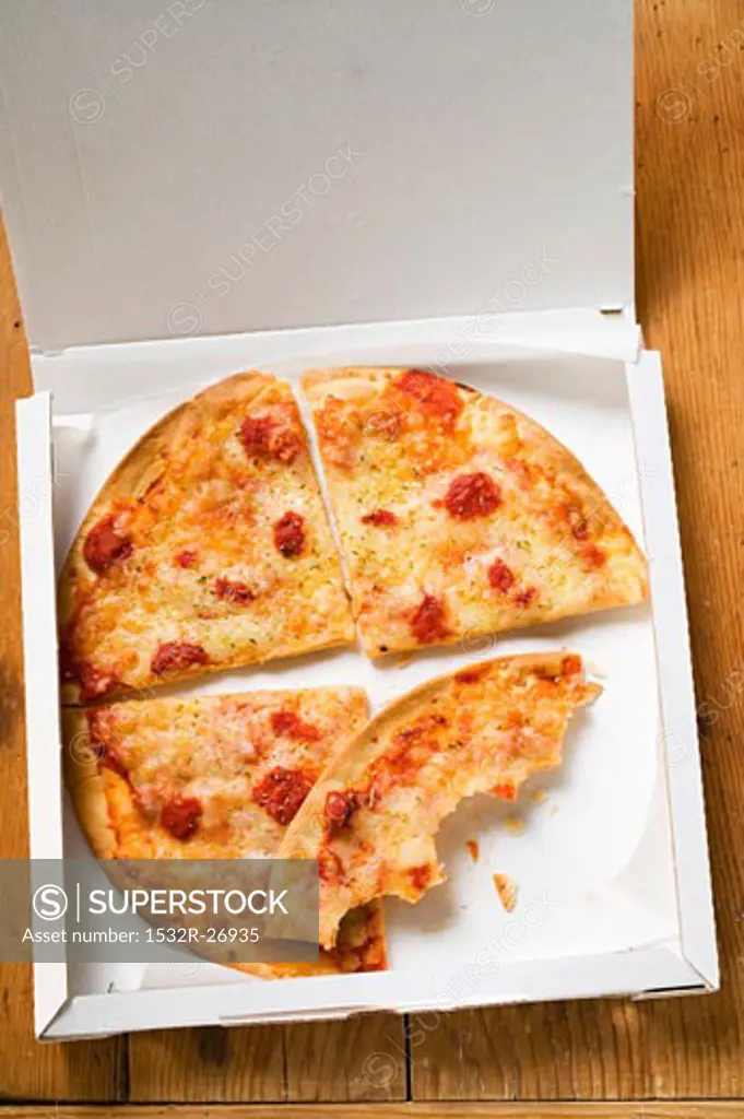 Pizza Margherita, in slices in pizza box