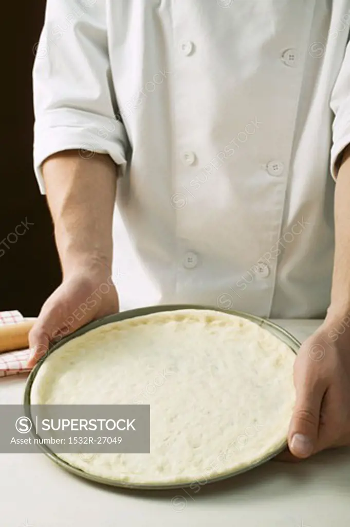 Pizza dough in baking tin