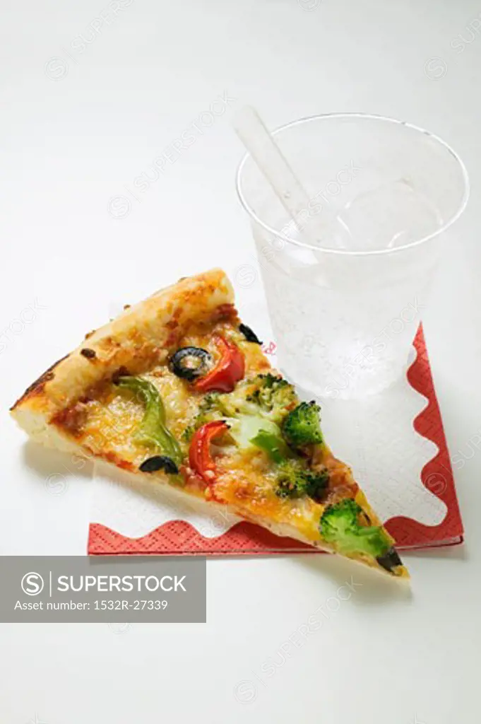 Slice of American-style vegetable pizza and mineral water