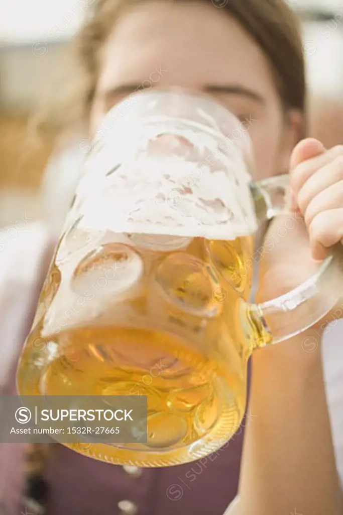 Woman drinking a litre of beer (Oktoberfest, Munich)